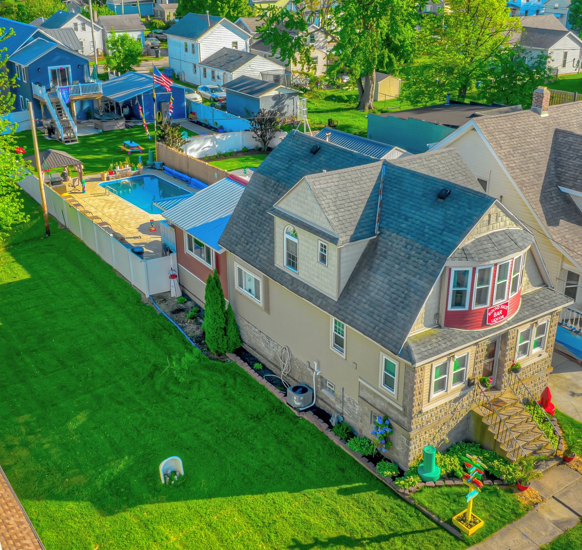 Drone view of both backyards and heated inground pool